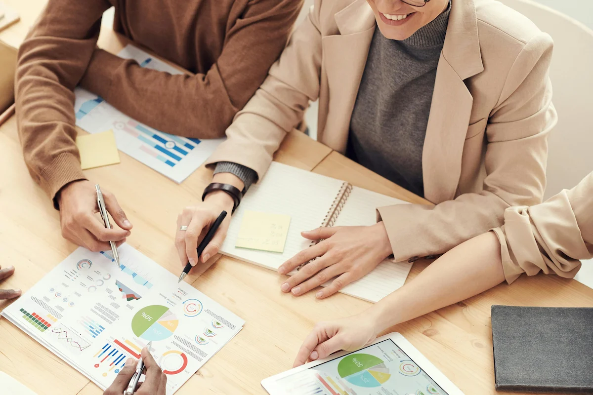 People meeting around a desk, discussing ideas in with a client